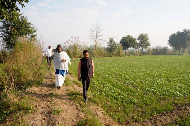 Mohanji walking the boundary of the temple land with the Core Committee